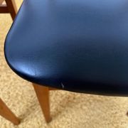 4 Scandinavian chairs in teak and black faux leather.