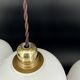 Set of 3 vintage bell-shaped pendants in white opaline with brown trim.
