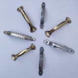 Seven art deco silver tone and brass handles