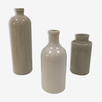 Trio of old sandstone bottles and jars