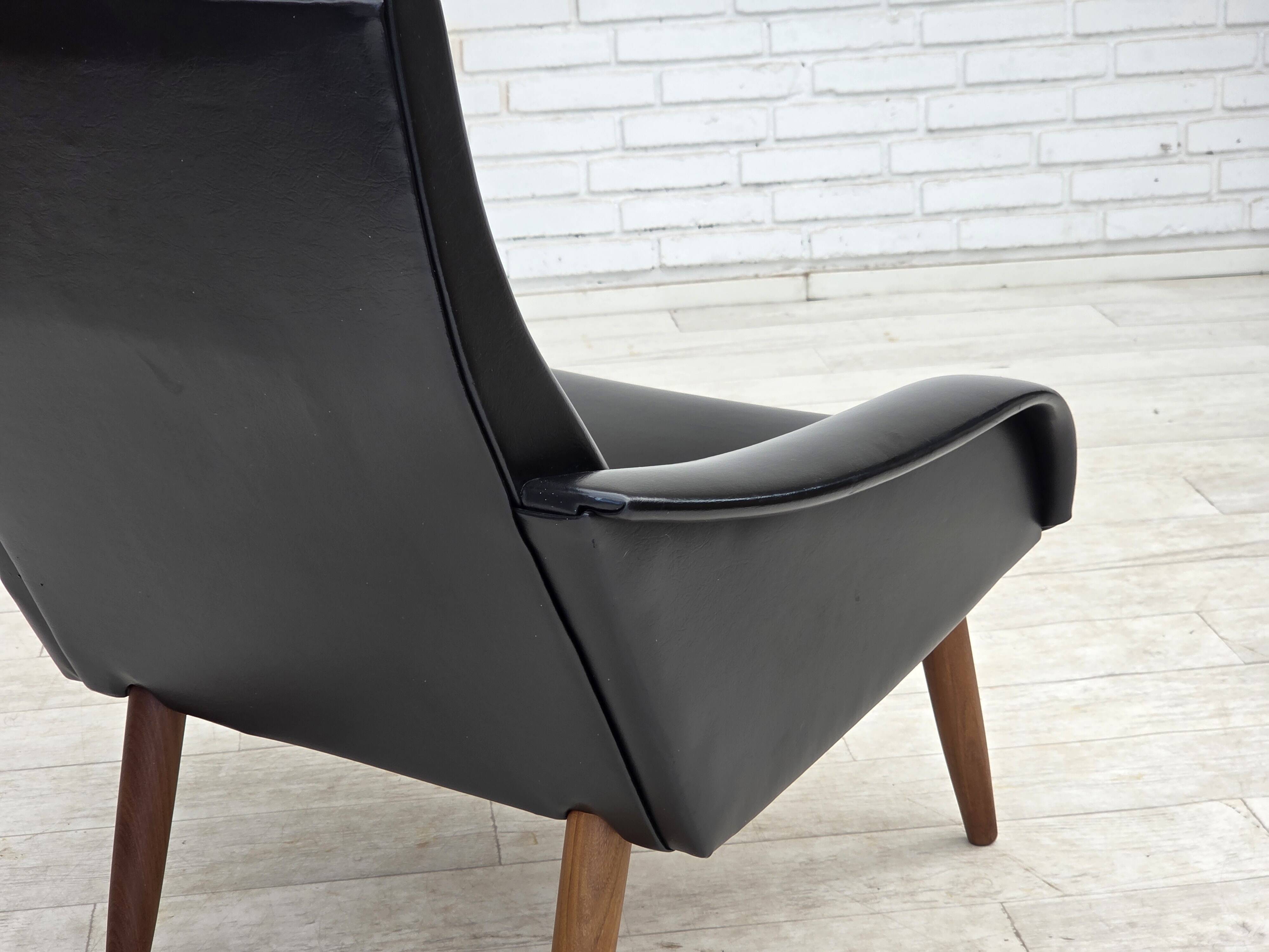 1970s, Danish armchair, black artificial leather, teak wood legs.