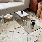 Set of 2 vintage nesting coffee tables in chrome metal and smoked glass.
