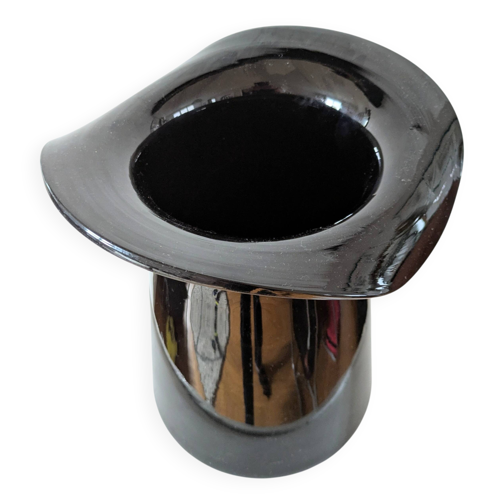 Large black glass vase topped with a 70s hat