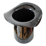 Large black glass vase topped with a 70s hat