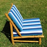Low armchair in eucalyptus wood with blue and white cushions