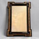 Antique wall mirror in blackened wood and gilded stucco, 19th-century Dutch style.