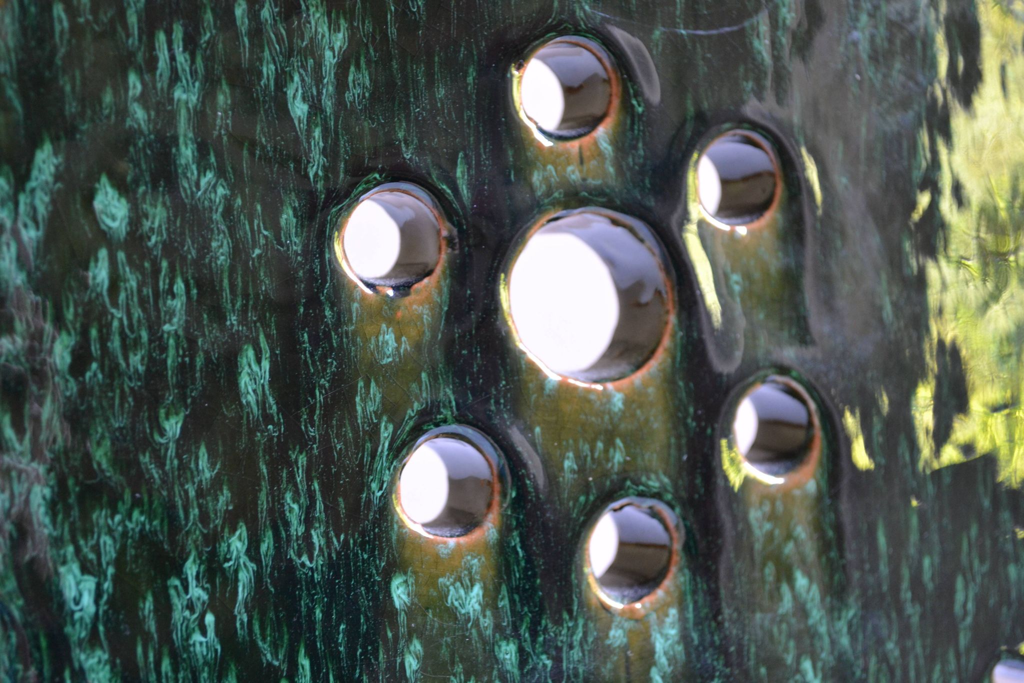Green ceramic sun candlestick from Tamegroute, Morocco.