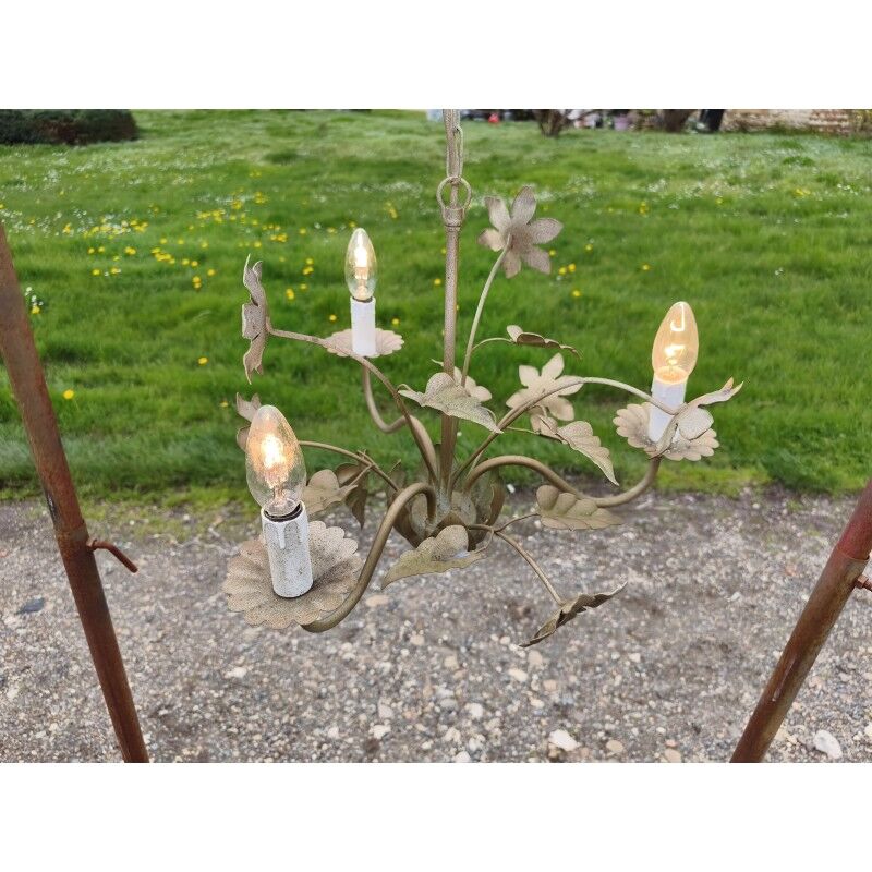Vintage gold metal chandelier with floral decoration.
