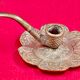 antique hand candlestick known as a rat of the cellar in bronze art Pipe