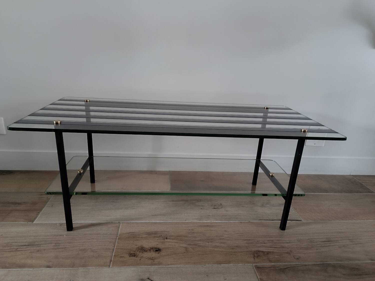 Vintage coffee table in glass and mirror strips.