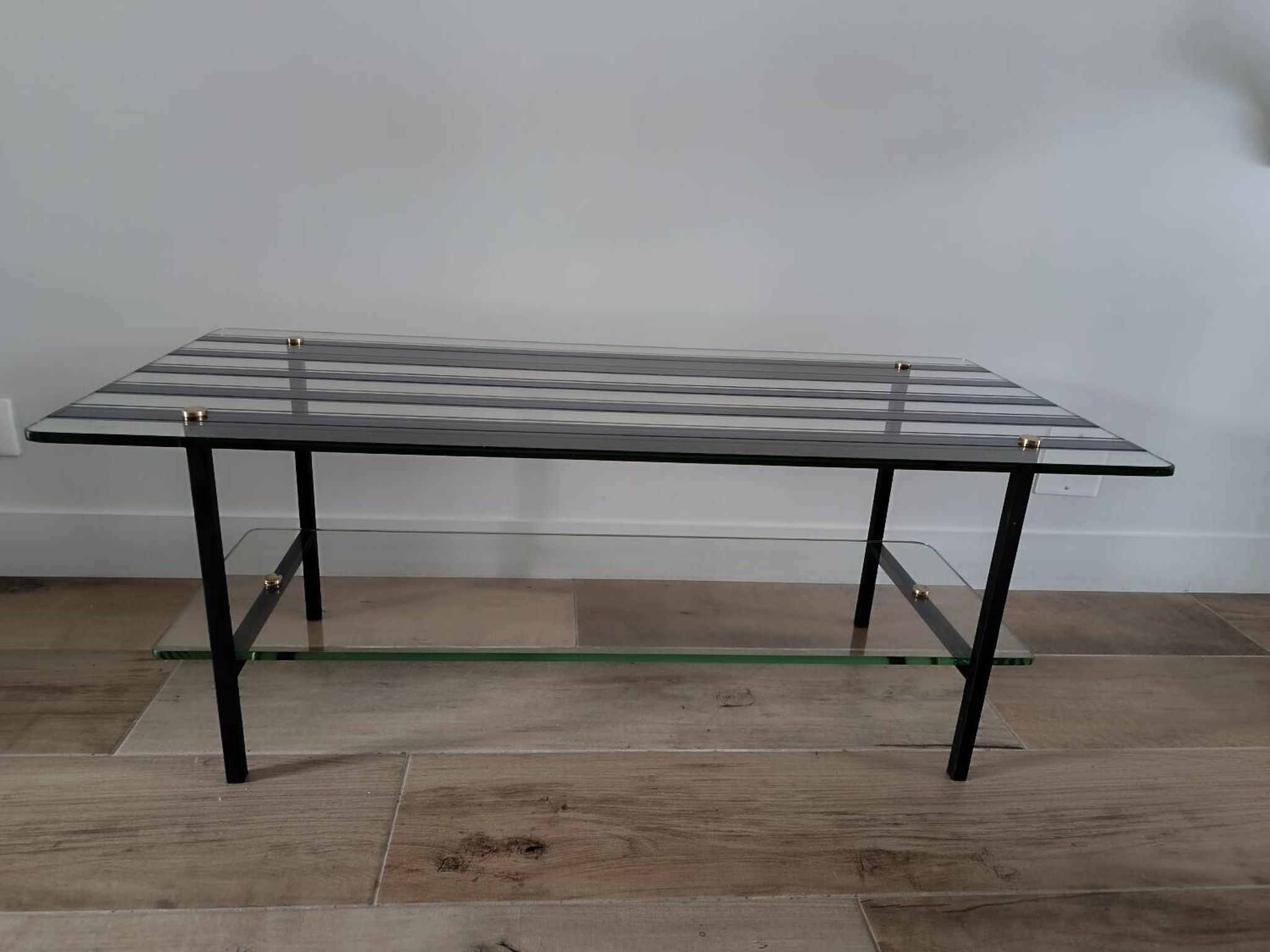 Vintage coffee table in glass and mirror strips.