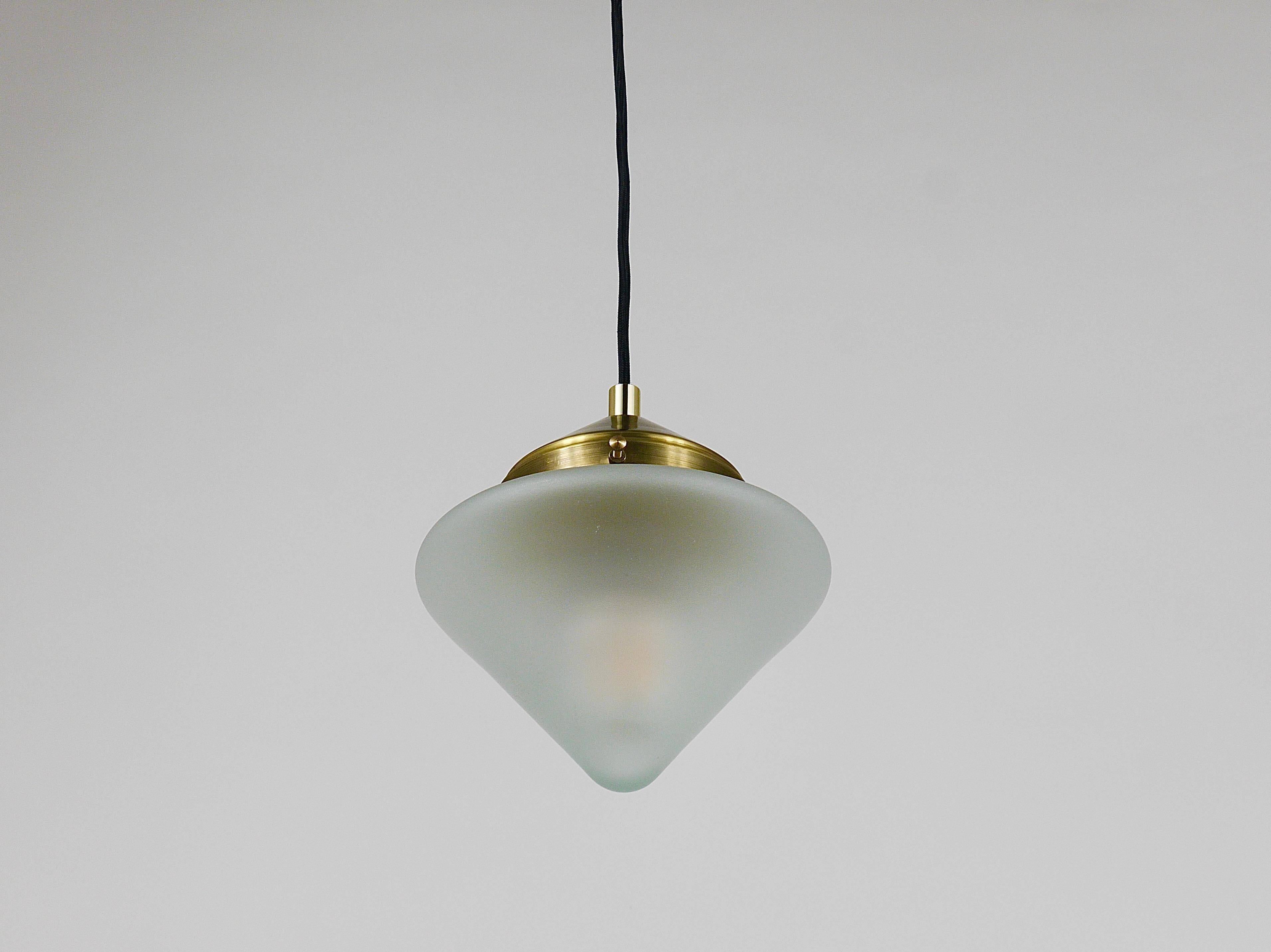 Up to 7 Art Deco brass pendant lights with conical glass shades, Vienna 1930s.