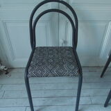Indus chair with tubular structure in slate gray metal waxed finish, upholstered seat.