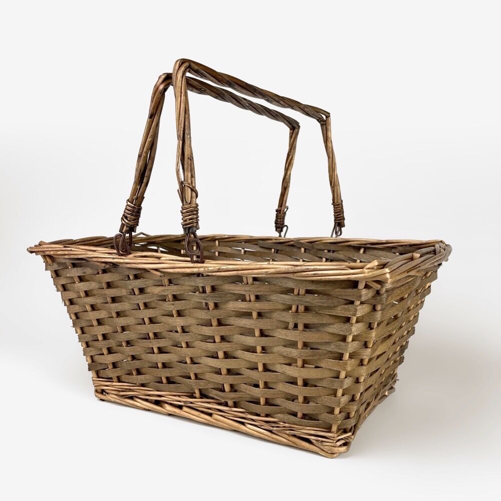Old basket made of woven wood splices and braided wicker