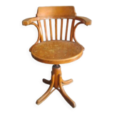 Old swivel office armchair in curved wood