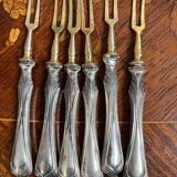 Set of knives and forks for fruits.