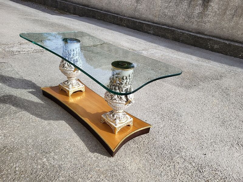Italian coffee table with glass top, wooden base, and porcelain legs