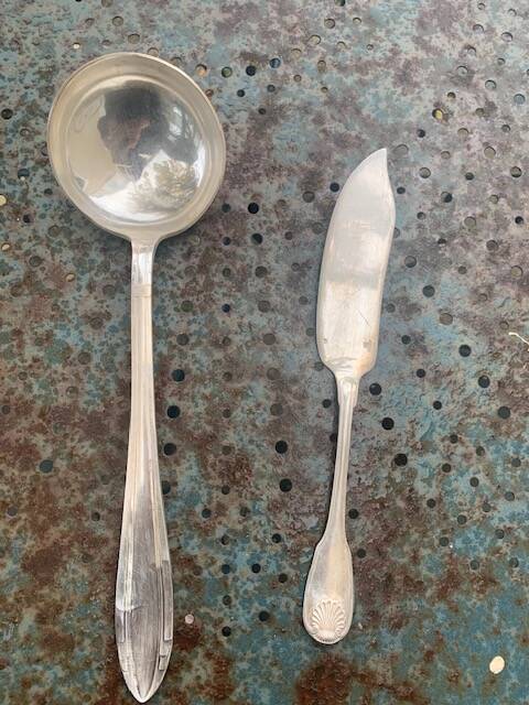 Lot of mismatched silver metal serving cutlery, a ladle and a fish knife