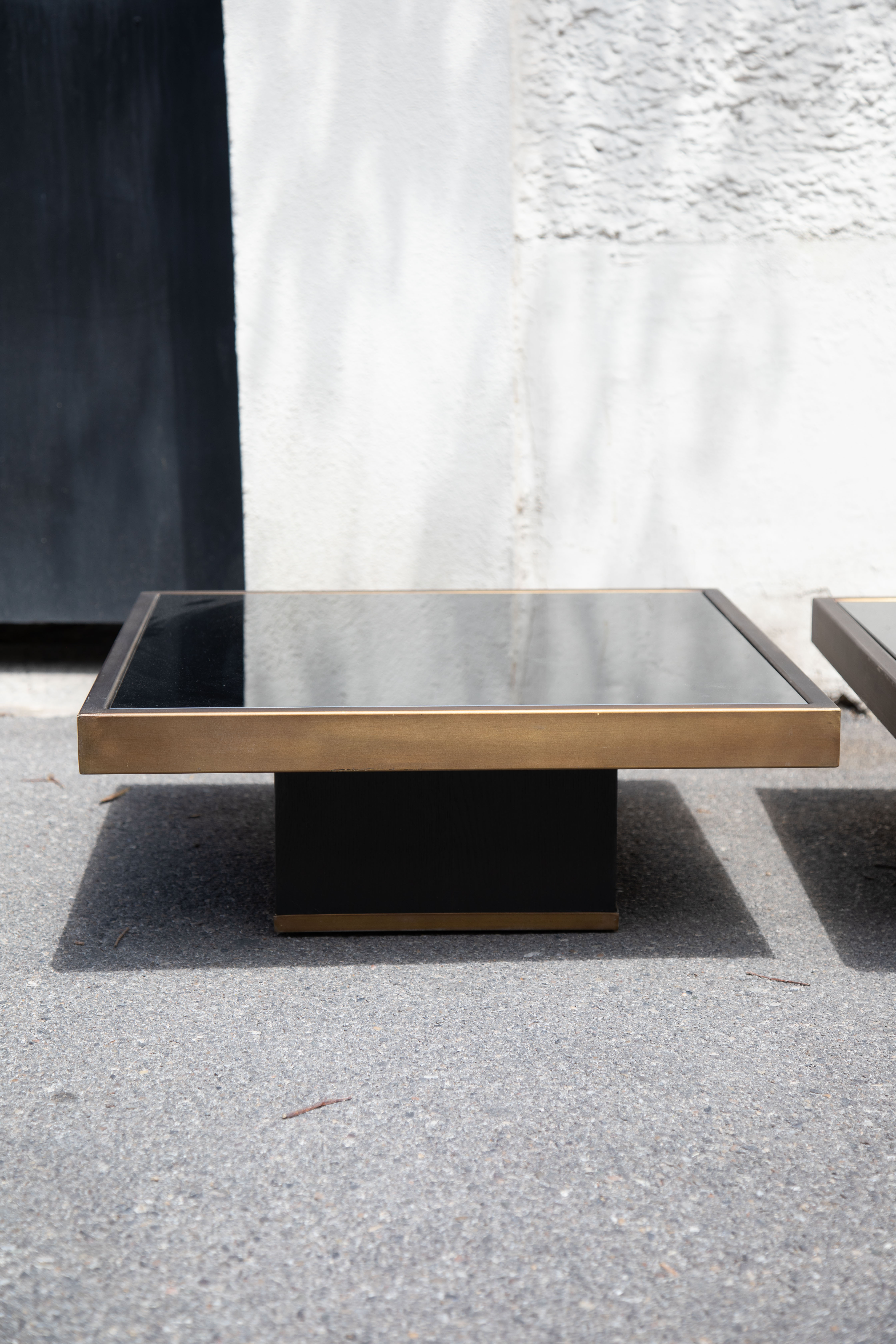 Pair of coffee tables brass black glass