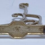 Three brass, chrome, aluminum hooks, early 20th century