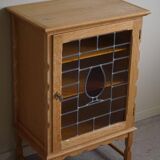 Scandinavian wardrobe in natural oak with a glass front.