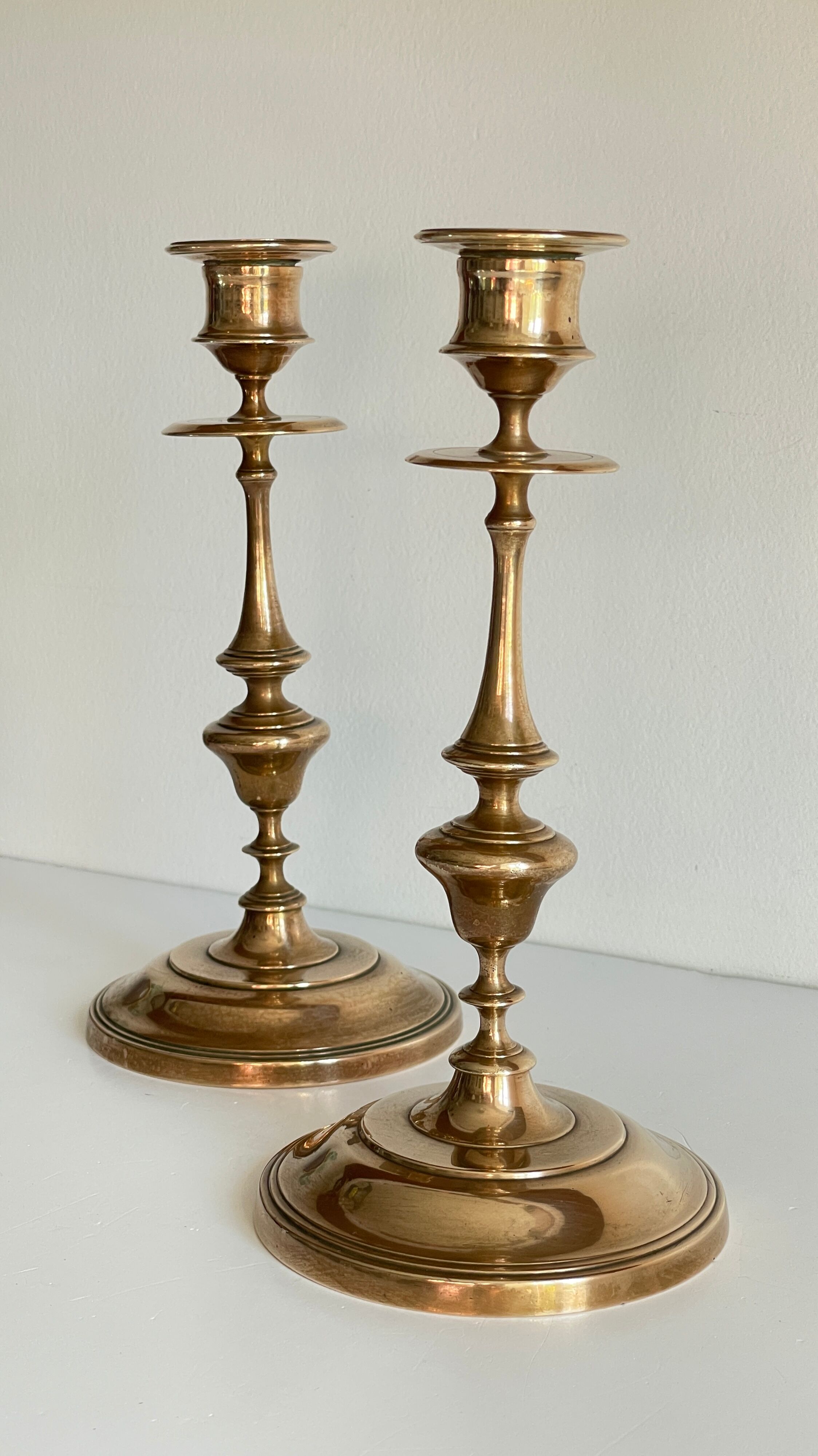 Pair of antique candle holders in solid brass
