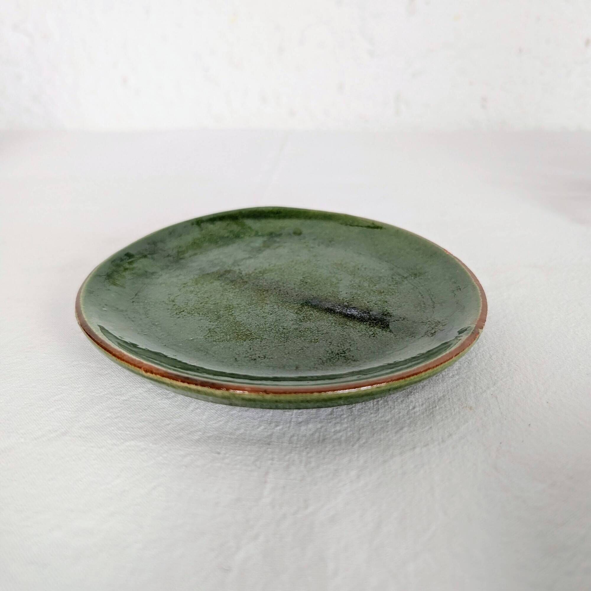 Small plate in glazed green earthenware