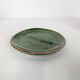 Small plate in glazed green earthenware