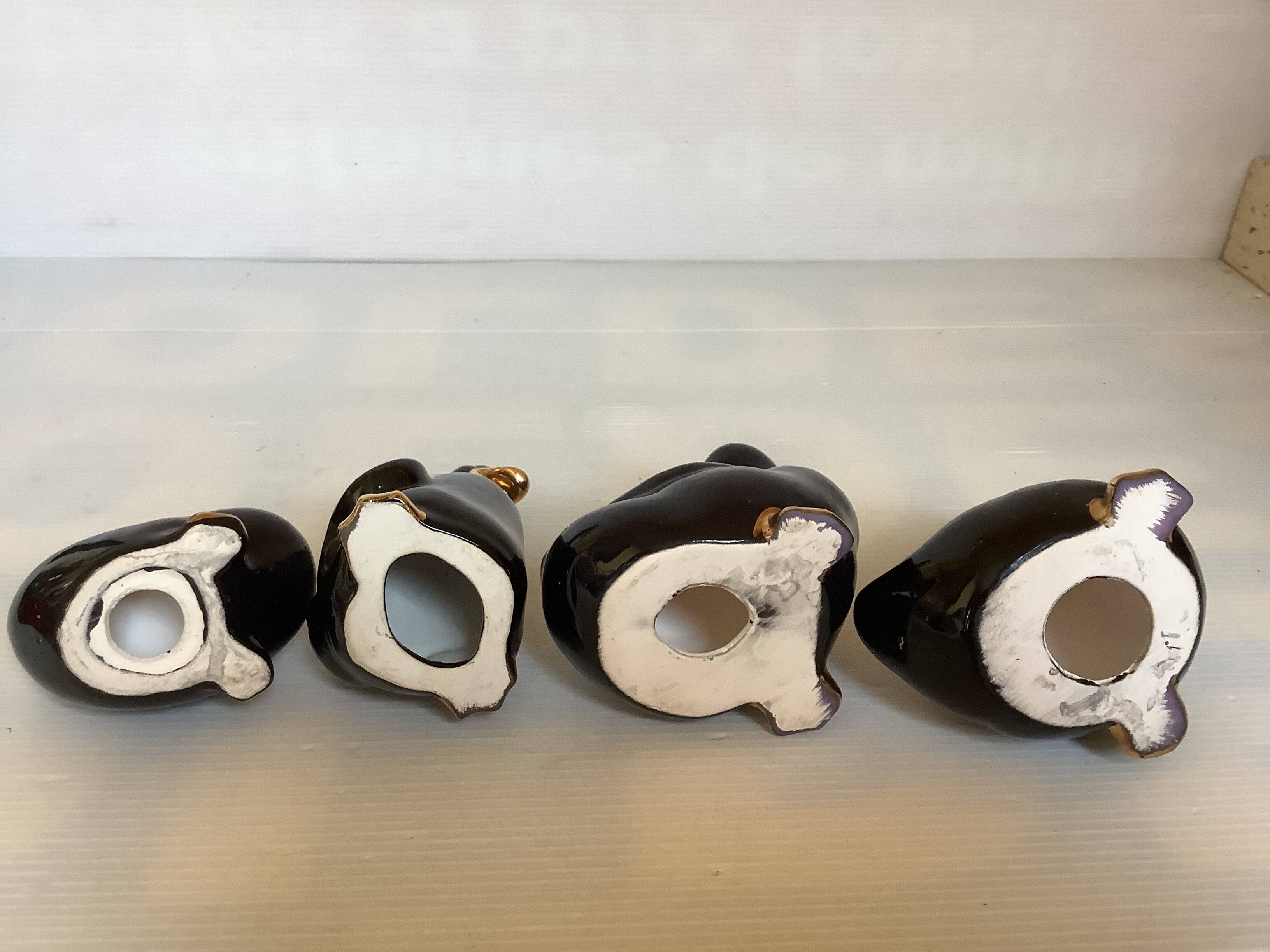 Four little black and golden ducks.