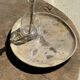 Petrified wood catchall or dish in beige with several grey spots in the centre.