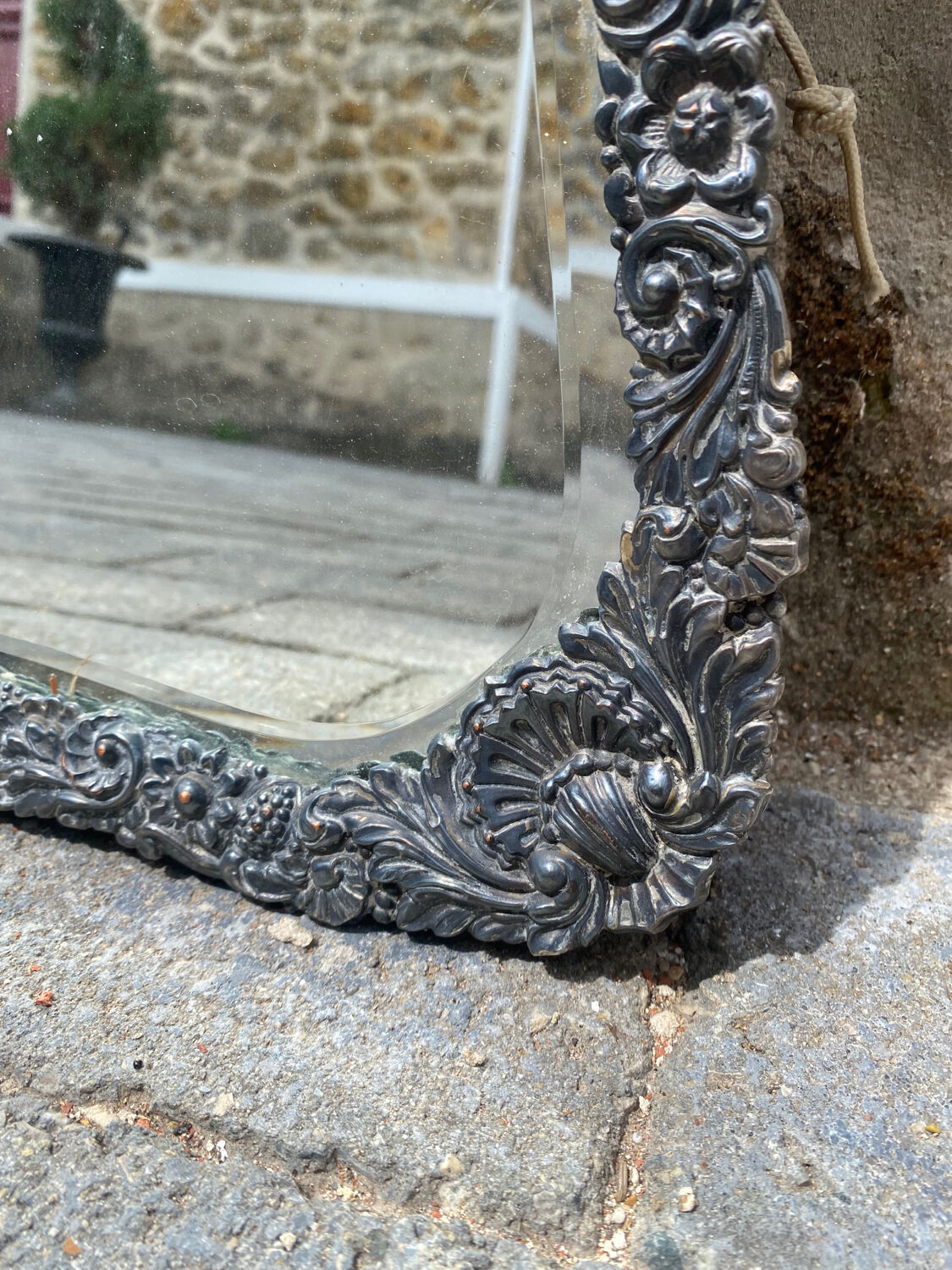 Old mirror carved in gray metal