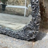 Old mirror carved in gray metal