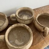 4 stoneware coffee cups and saucers