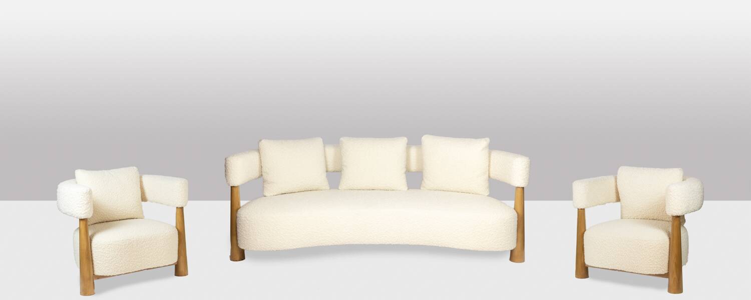 Pair of “bean” shaped armchairs, in blond beech. Contemporary work.