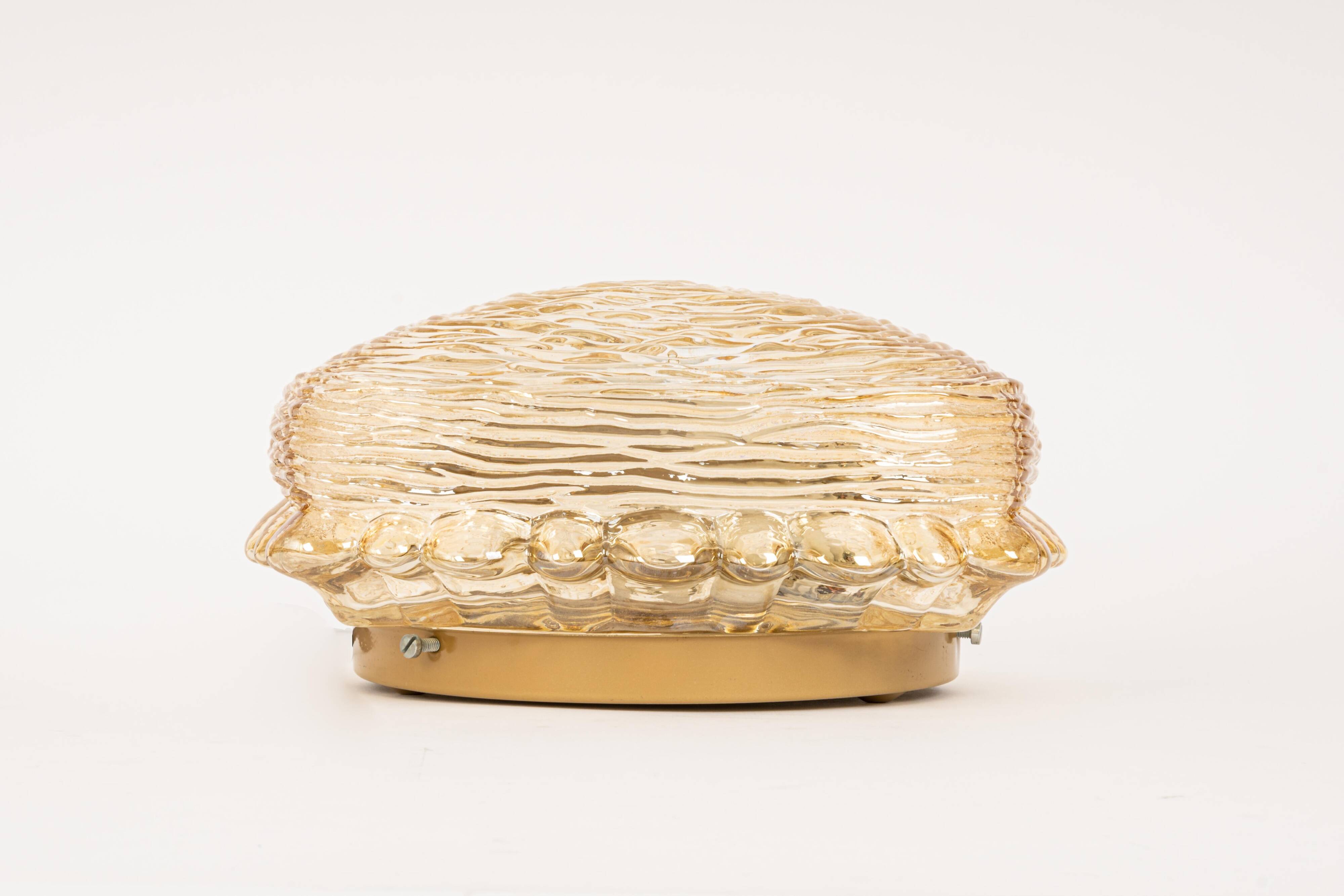 Pairs of amber glass wall lights in the shape of a fingerprint, Germany, 1970s.