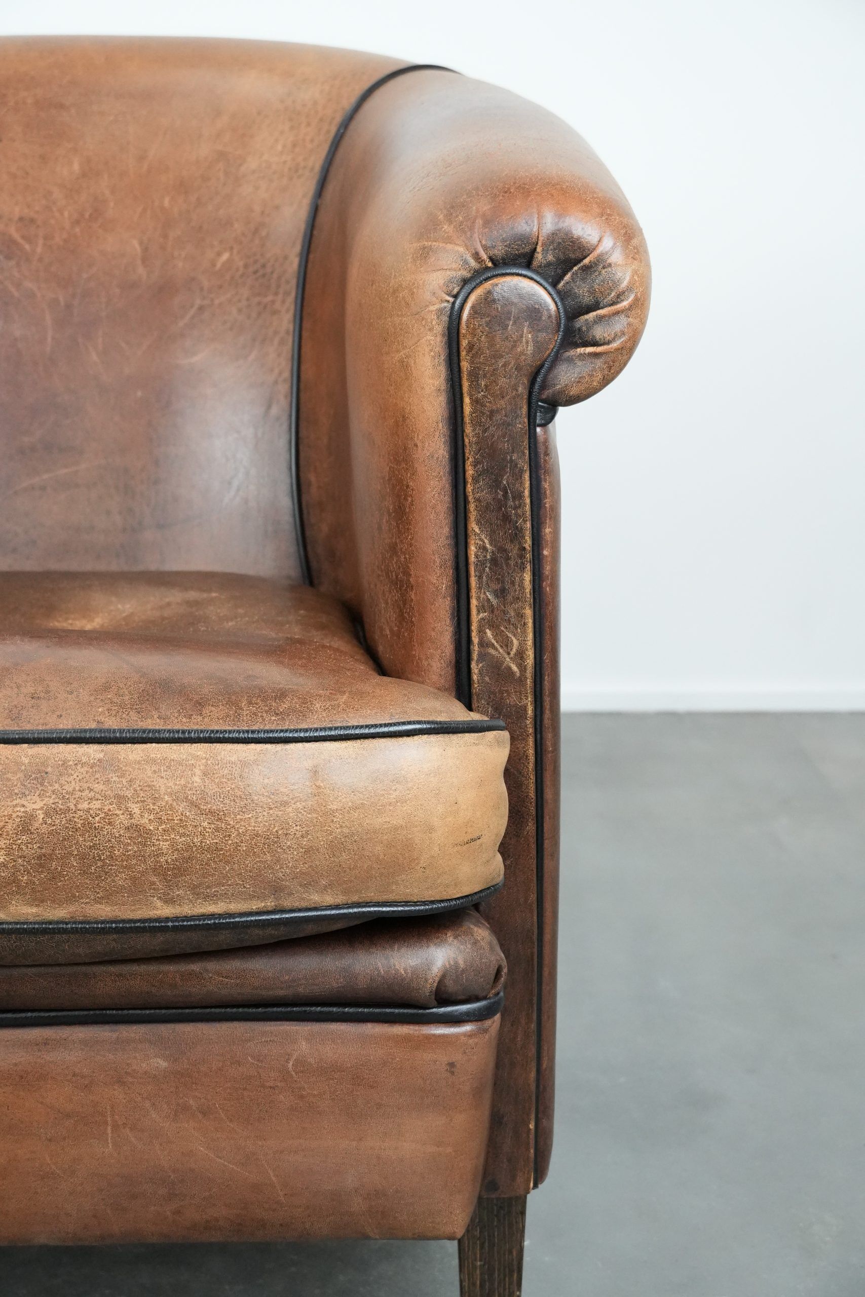 Sturdy vintage sheepskin club armchair with a beautiful patina