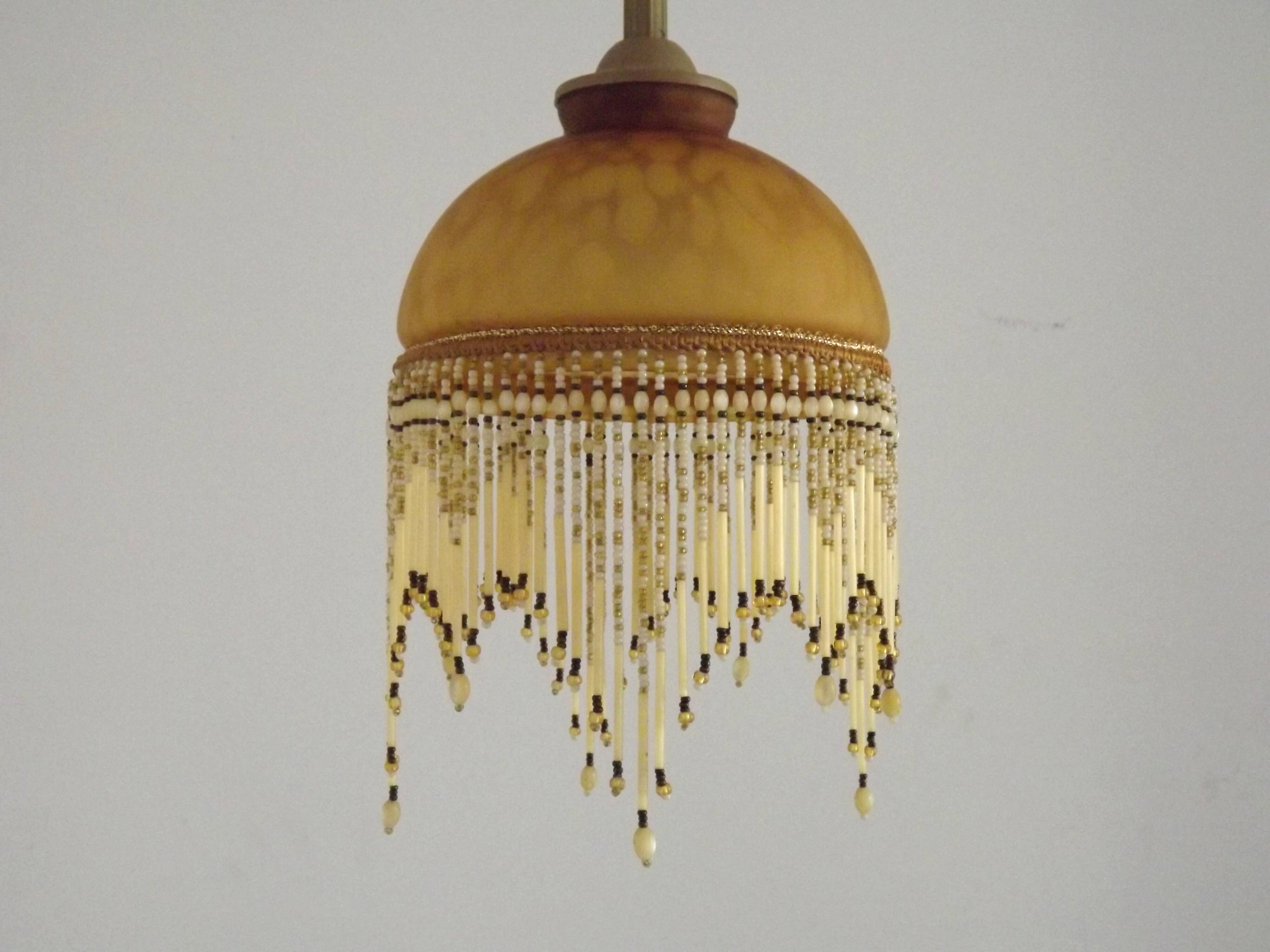 Vintage French amber mottled glass hanging ceiling light with beaded fringe.