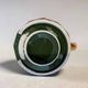 Dark green ceramic decorative jug with golden trim.