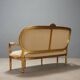 Neoclassical canapé in gilded wood