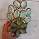 Gold metal wall light with light blue tassels