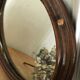 Old oval mirror with wooden frame