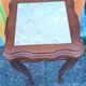 Curved leg wooden stand with a marble top.