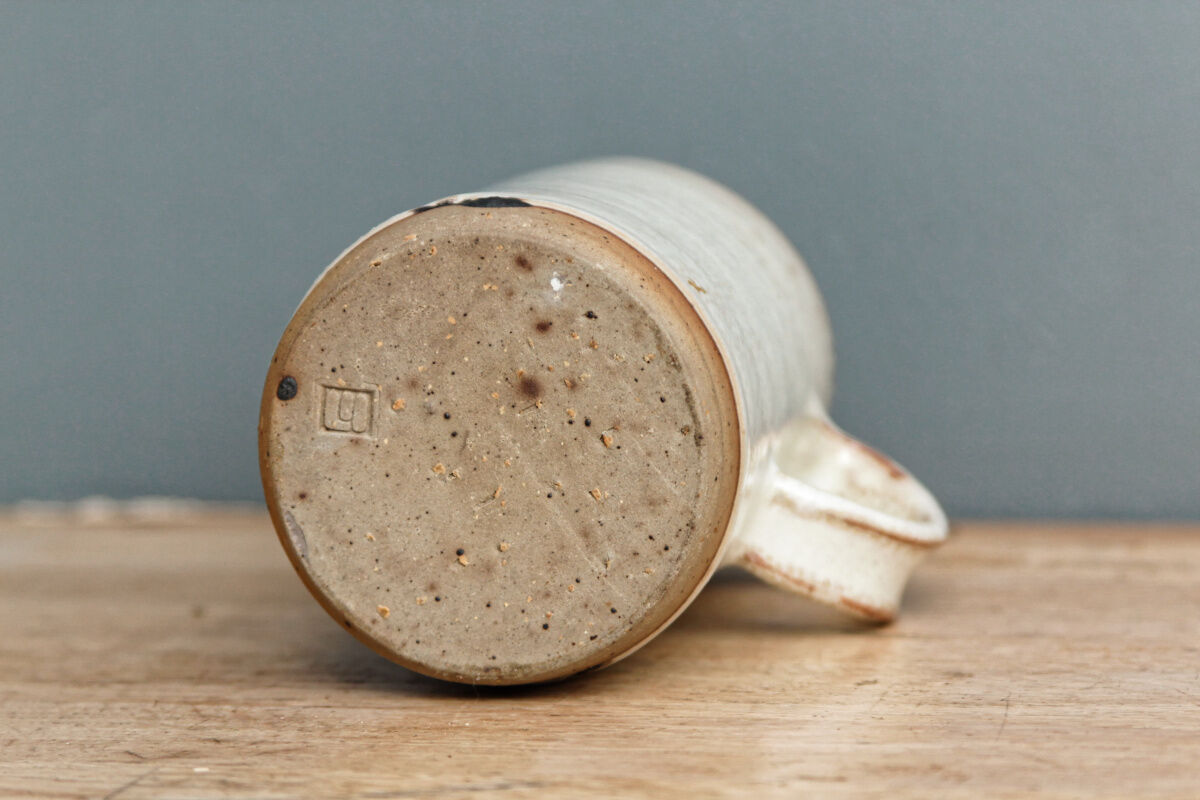 Enamelled sandstone milk jar, signed