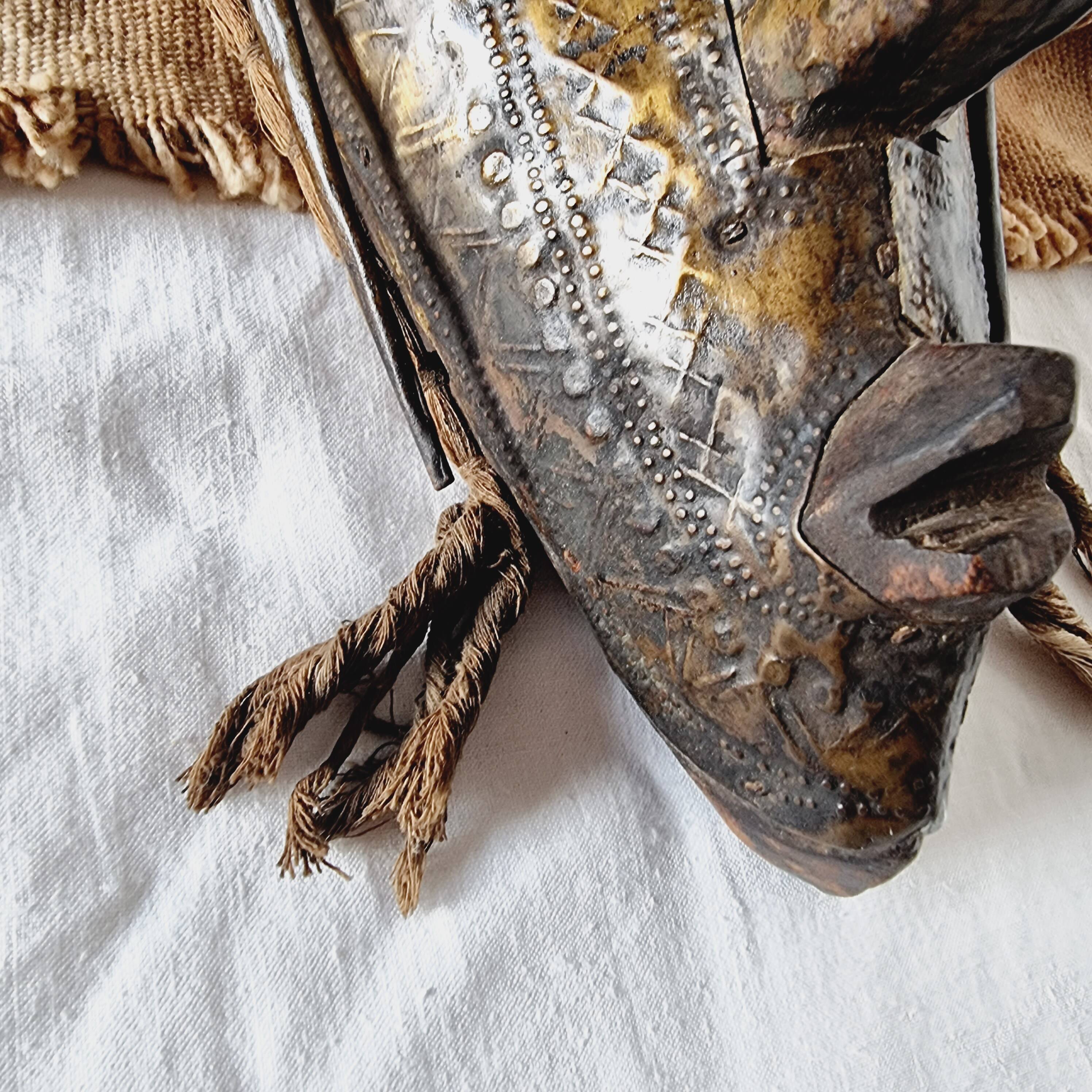 African mask from Mali from the N'Tomo tribe of Marka covered in chiseled brass