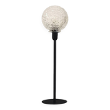Table lamp with an antique textured glass globe