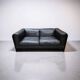 Two-seater sofa in black leather, designed by Tito Agnoli for Poltrona Frau, Italy, 1980s