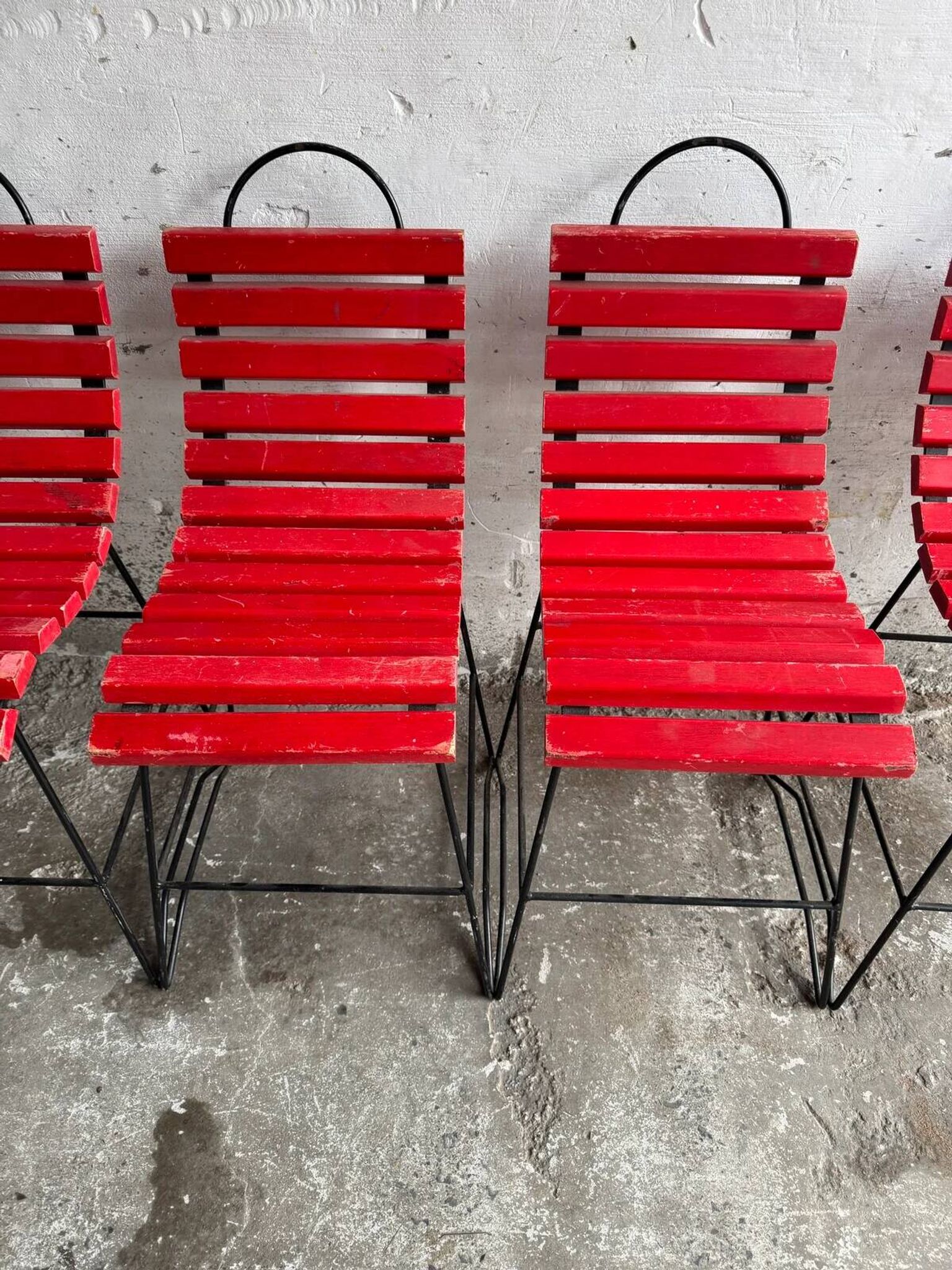 Red slatted chair with a black metal frame.