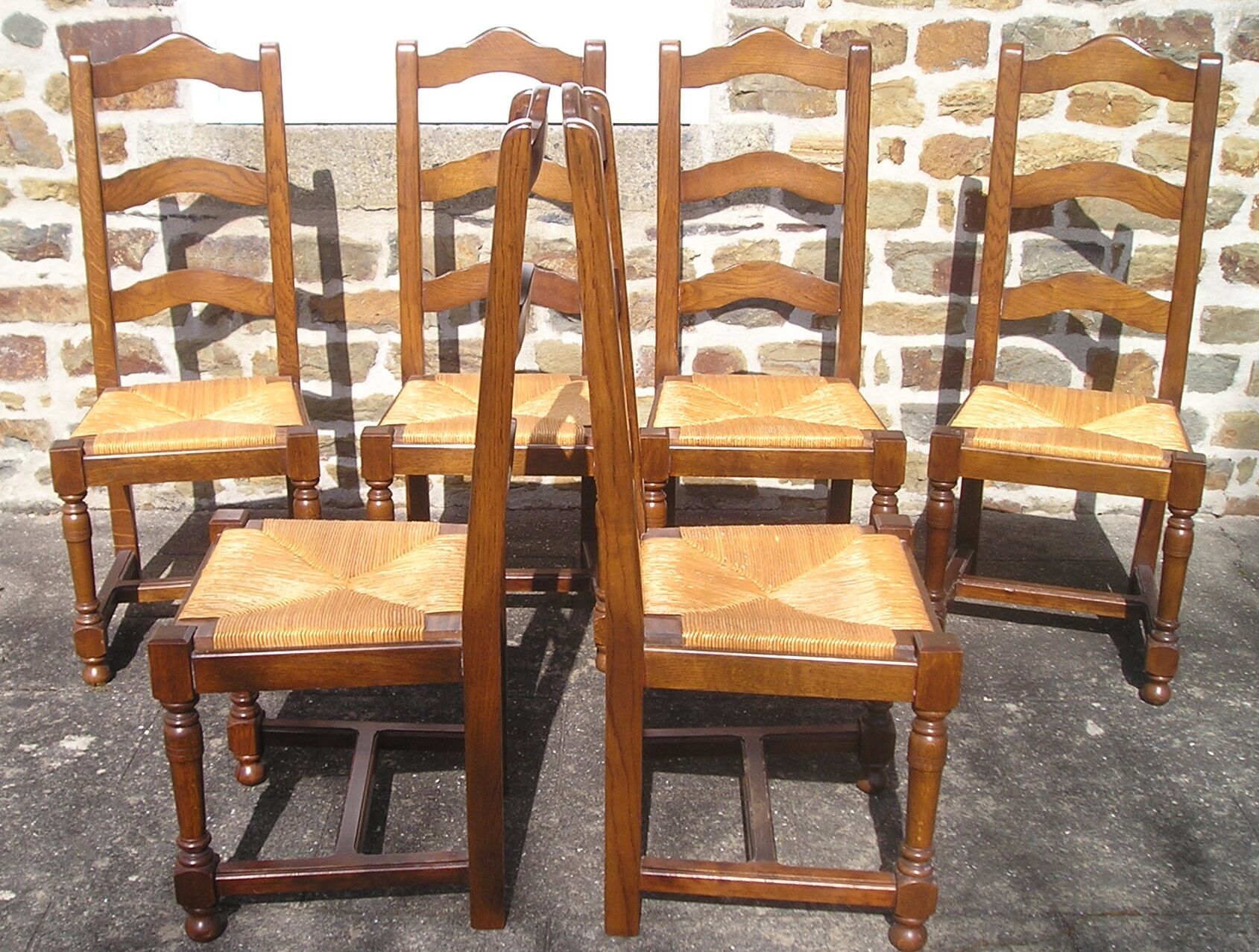 Set of 6 oak dining chairs with high backs and straw seats