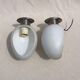 Pair of brushed steel appliques, half-egg opaline, 1970