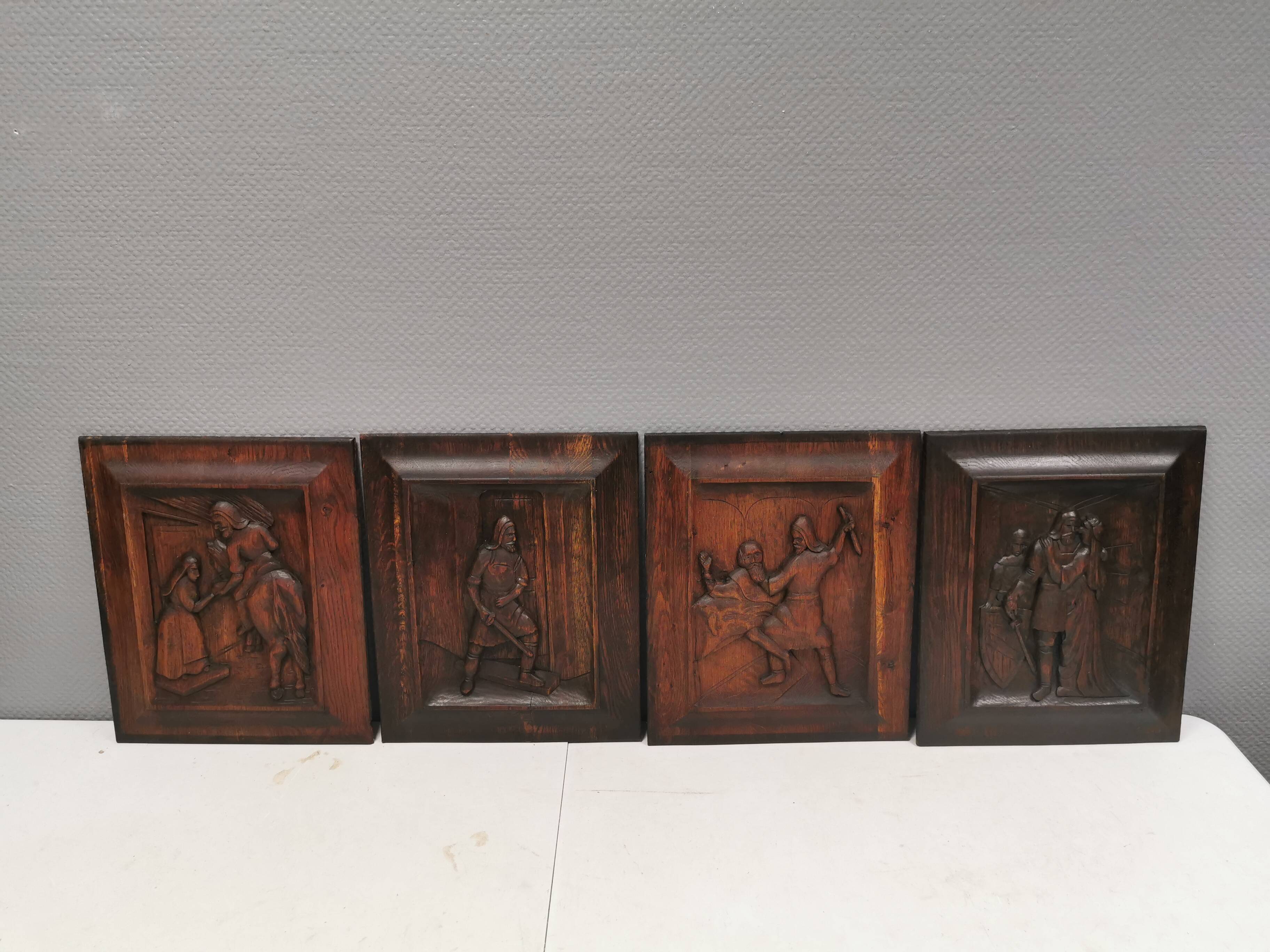 Four old wooden carvings to hang on the wall.